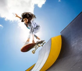 Schilderijen op glas Skateboarder doing a jumping trick © Andrey Burmakin