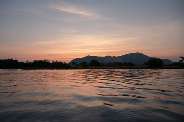 Sunset sky with mountain range in countryside at Lam Thaphoen reservoir
