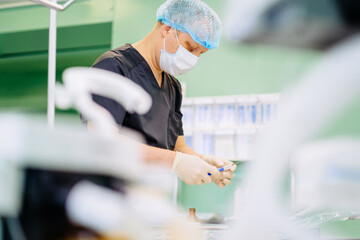 Doctor anesthesiologist draw syringe medicine, drug, vaccine from glass vial, Prepare for inject to patient in operatinh room at hospital.
