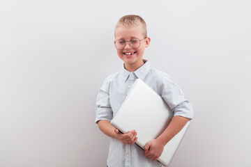 A smiling school-age boy rejoices in success and a good grade from homework