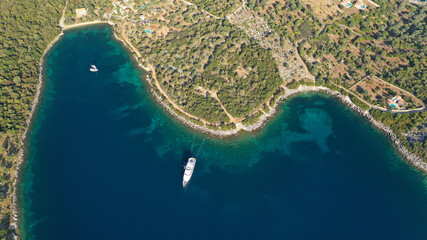 Aerial drone photo of power boat anchored in tropical Caribbean turquoise bay with calm sea