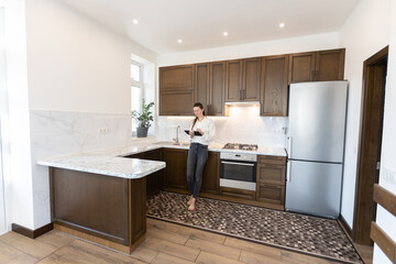 Woman working in her kitchen from home in a modern scandinavian kitchen