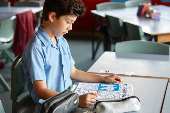 Primary school student in classroom working on maths homework