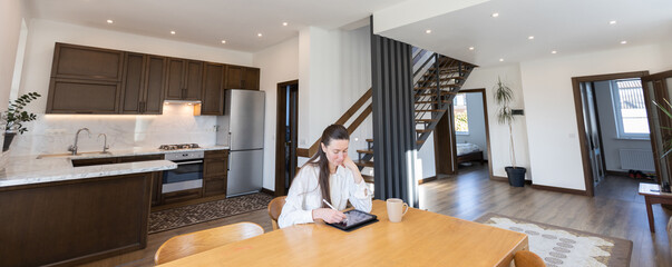 Woman using a phone in her living room. Modern living room interior in scandinavian minimalist style