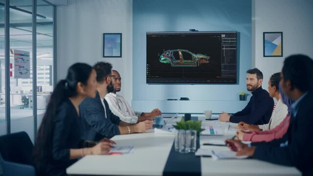 Multi-Ethnic Office Conference Room Meeting: Team of Industrial Engineers, Technicians Talk, Use Digital Interactive TV with 3D Car Concept. Eco-friendly, Green Renewable Energy Vehicle Prototype