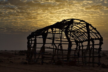 Naklejka premium West Africa. Mauritania. A frame made of wooden sticks tied with fabric scraps in a settlement of nomads of the Sahara Desert. Such frames are sheathed with animal skins and dense fabrics.