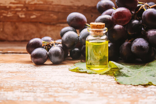 Extract of grape oil in a small jar. Selective focus. food