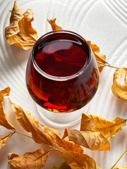 full glass of cognac spring leaves autumn drink alcohol