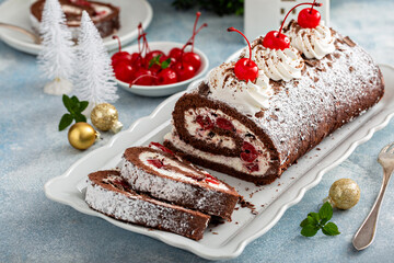 Black forest cake roll with whipped cream and cherries