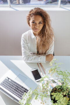 Accomplished looking professional young woman at her desk