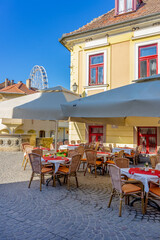 Colorful Dobo Square with restaurant tables