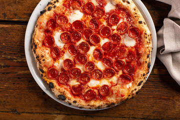 Pizza Napolitana or Naples style with tomato sauce, cheese and pepperoni - obrazy, fototapety, plakaty