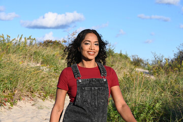 beautiful young woman outside at the beach, in a park