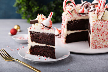 Peppermint bark and chocolate cake for Christmas on a festive background