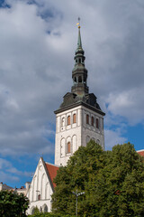 Fototapeta na wymiar The steeple of St. Nicholas' Church (Niguliste) on a sunny autumn day. Tallinn, Estonia.