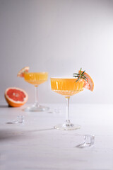 Two orange coctails and grapefruit on white background