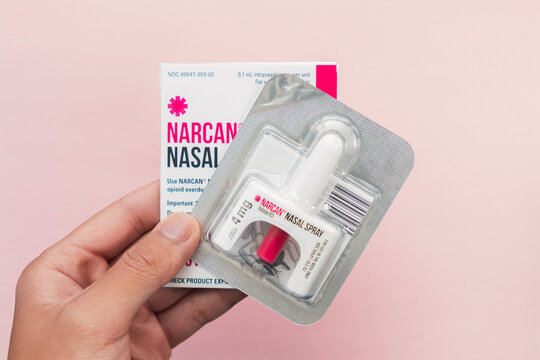 Hand holding a Narcan Evzio Naloxone nasal spray opioid drug overdose prevention medication