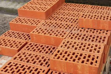 Obraz na płótnie Canvas red hollow brick, rows of bricks on a pallet