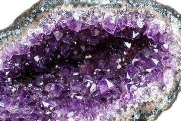 Macro Mineral Stone Amethysts in the rock on a white background