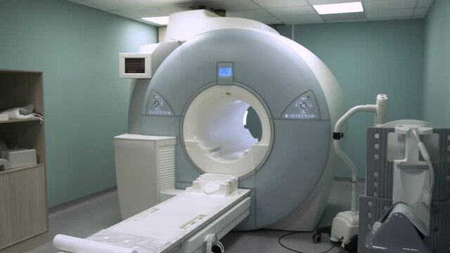 Bright room with modern CT scan machine