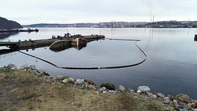 A sunken ship against the backdrop of the northern seaport of Murmansk. Ob Bay.