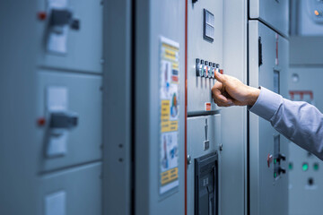 Electrical engineer push red button for check load center cabinet or consumer unit for maintenance in main power distribution system room. - obrazy, fototapety, plakaty