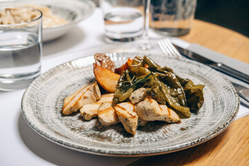 Healthy lunch food grilled chicken breast with vegetables sweet peppers and potatoes