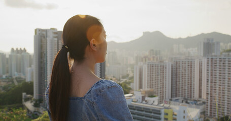 Fototapeta premium Woman look at the city in Hong Kong