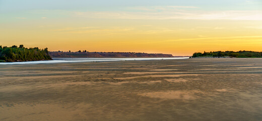 Fototapeta na wymiar Sunset over a sandy beach on the Volga river, Russia.