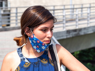 Latin Woman with a Sad and Tired Look Wearing a Mask Under her Mouth