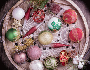 Set of Christmas decorations in wooden tray on grunge background. Holiday concept. Flat lay, top view