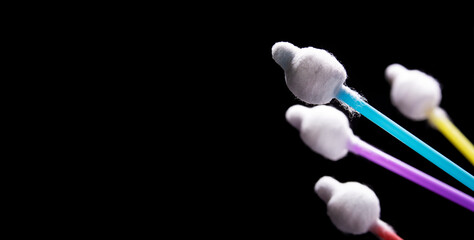 Colorful cotton sticks, cotton buds  isolated on black background.