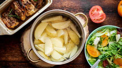 Cooking boiled young potatoes in a saucepan.