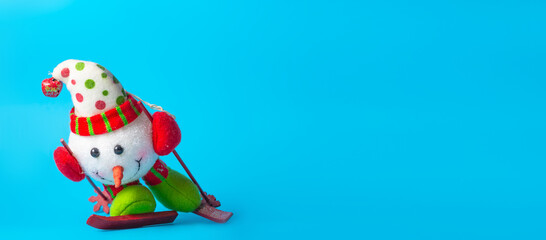 New Year's snowman on a blue background. Christmas or New Year theme. Banner. Place for your text.