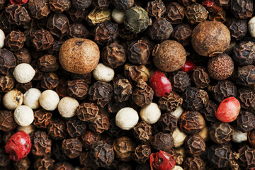 A mixture of peppercorns as a textural background in full screen.