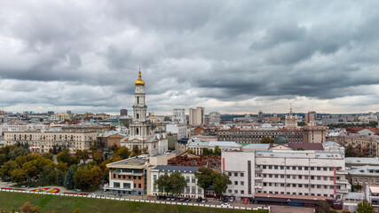 European city aerial view, autumn Dormition Cathedral and downtown roofs with gray heavy clouds in Kharkiv, Ukraine