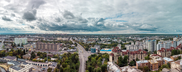 Autumn city aerial panorama from Klochkivskyj Descent on Lopan river area. Rooftop buildings and streets with epic cloudscape in Kharkiv, Ukraine