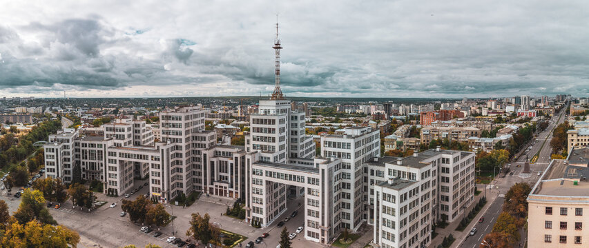 Autumn city aerial panorama view on Derzhprom historic architecture building from Freedom Svobody Square with epic cloudscape in Kharkiv, Ukraine. Color graded