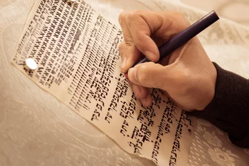 Fotobehang A writer's hand, practices decorating letters from a Torah scroll written on parchment in Hebrew, (for the editor - the Hebrew letters are random - without meaning) © yosefhay
