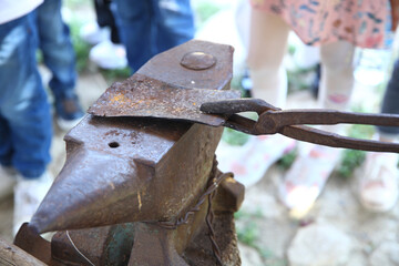 Detail shot of metal being worked at a blacksmith forge . Hardening of the knife. Hardening of the working tool .