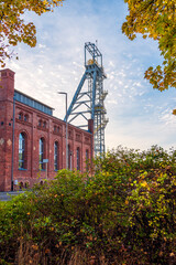 Engine room building and mine shaft tower "Krystyn" in former coal mine "Michal" in Siemianowice, Silesia, Poland. Blue sky in the background.