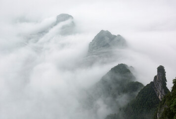 Aerial landscape image of mountaintops shrouded in white clouds. - 464112795