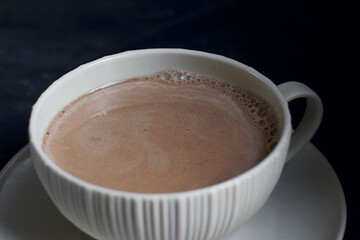 Hot cocoa in a mug on the table. Warming drink