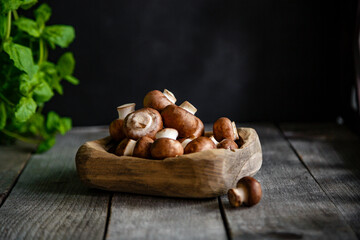 Small Royal champignons in a wooden bowl