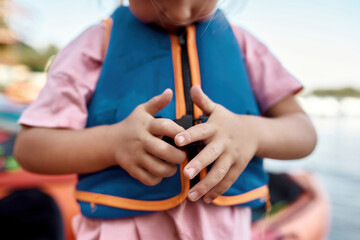 Little girl zipping life west on beach coast