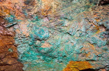Background from dracocene crystals of stones. Fluorite stone in the rocks of the adit. Mineral stones in their natural environment. Semiprecious stones texture.