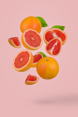 Fresh grapefruit sliced on pastel pink background. Minimal fruit concept. Vitamins, healthy diet concept.