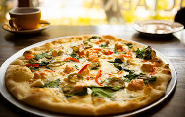 Pizza is on the plate on the wooden table 