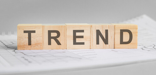 trend word on wood cube blocks on gray background.
