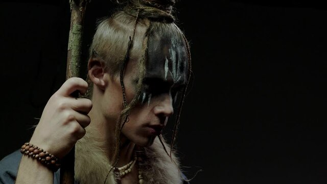 Elf with stick and dreadlocks whispers plagues on black